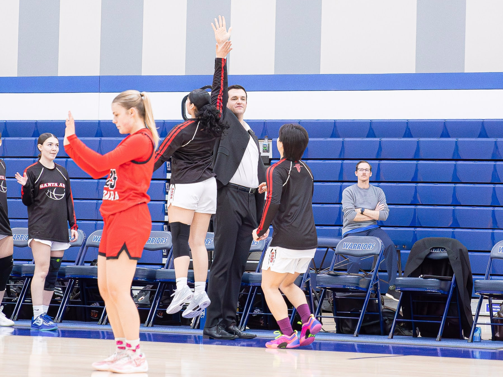 Santa Ana College sideline high five during warmups